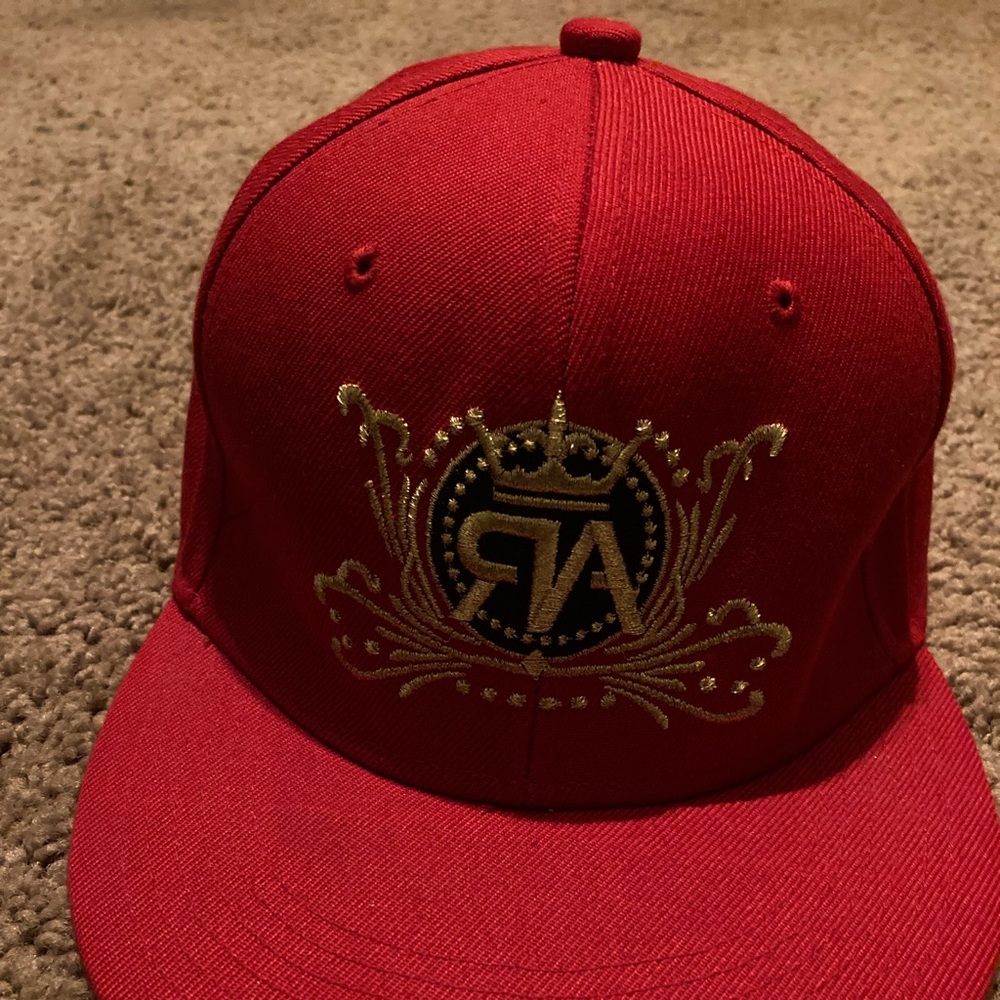 A Red , Gold , And Black “AR” Hat